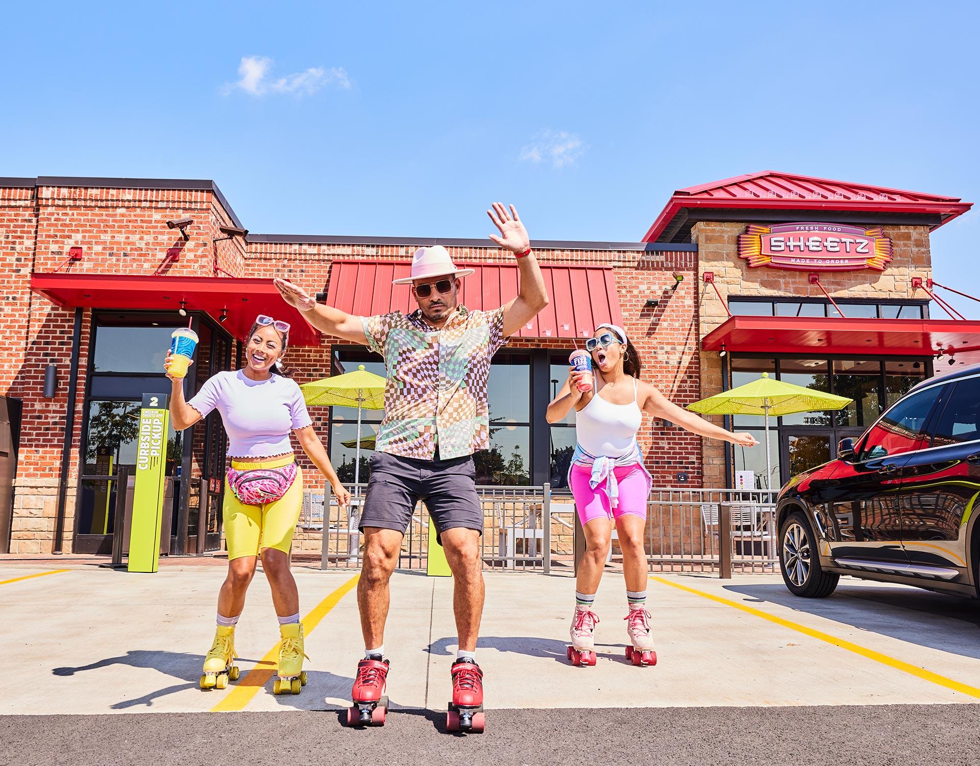 3 people roller skating in front of a Sheetz store in 1980's style clothing