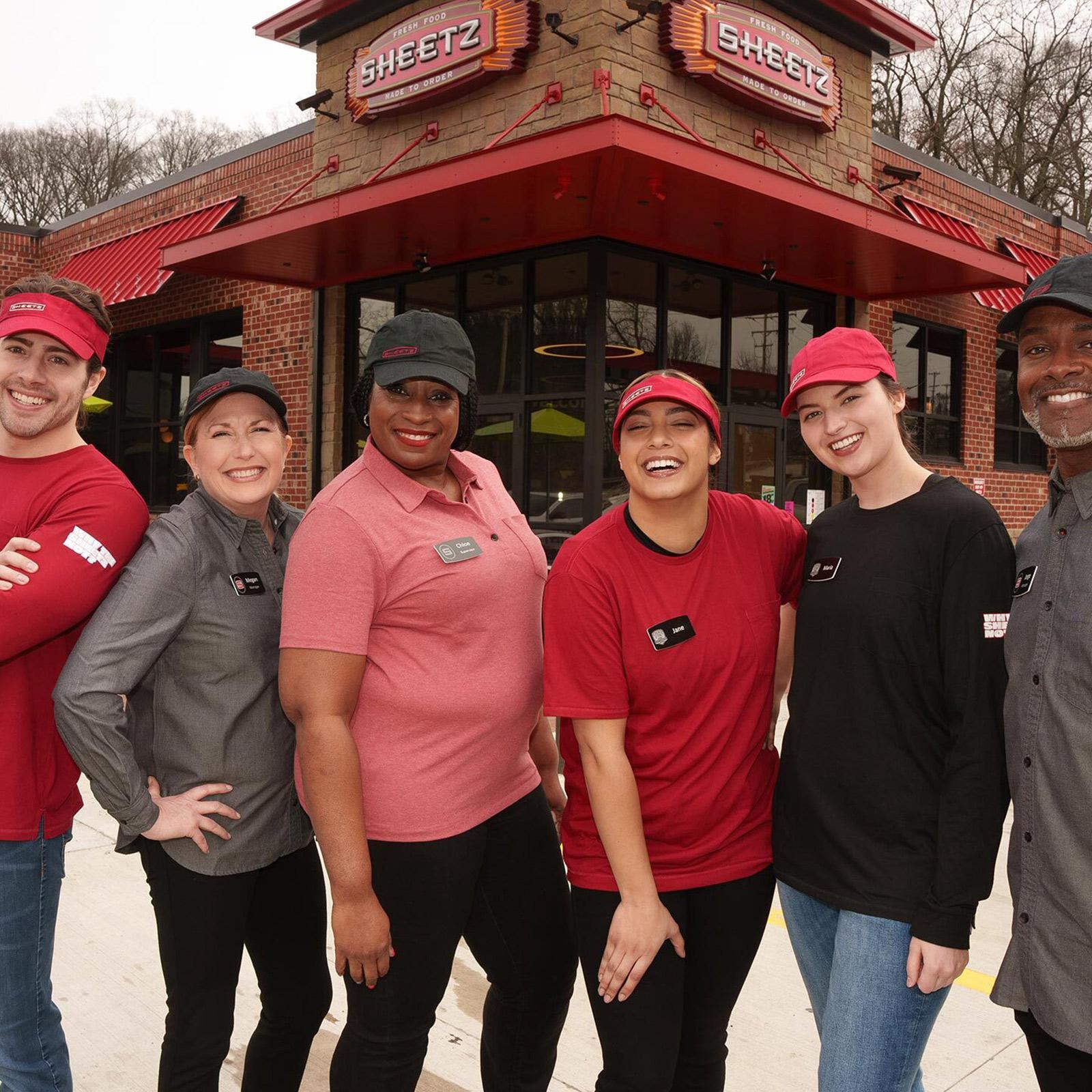 group of Sheetz employees in front of a Sheetz store