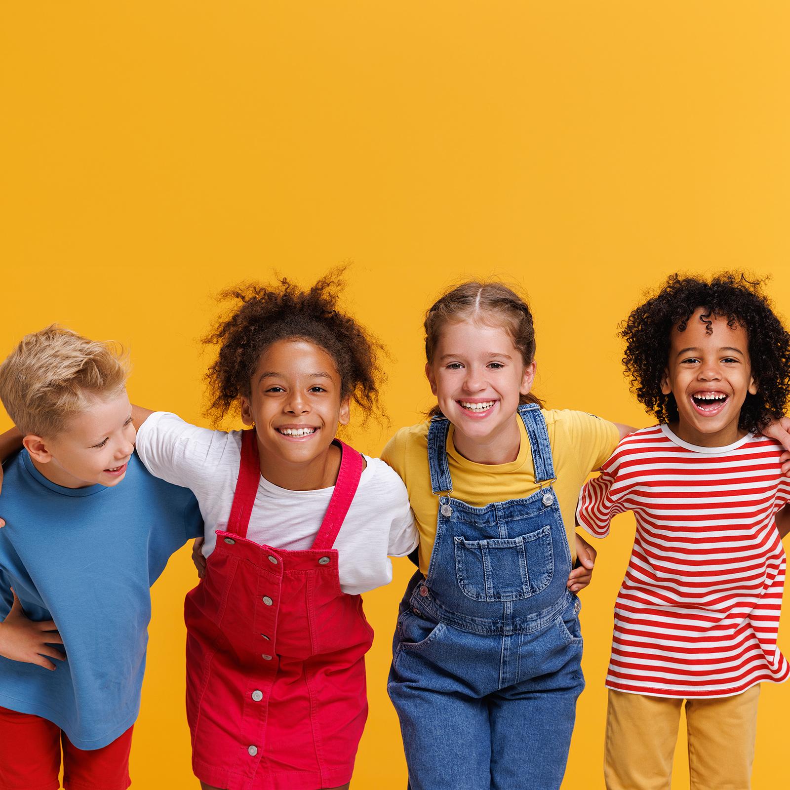 group of kids smiling outside